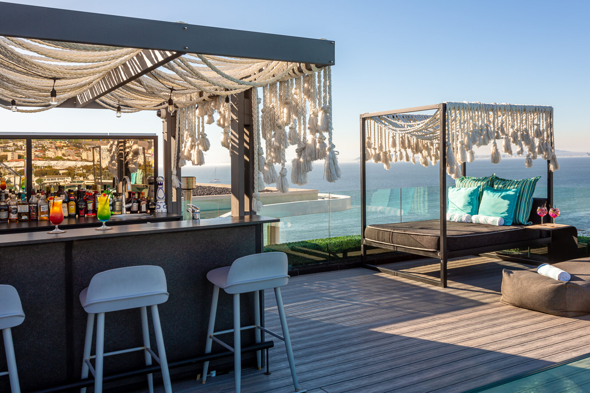 A rooftop deck with a luxurious bar, a lounger and panoramic views of the sea