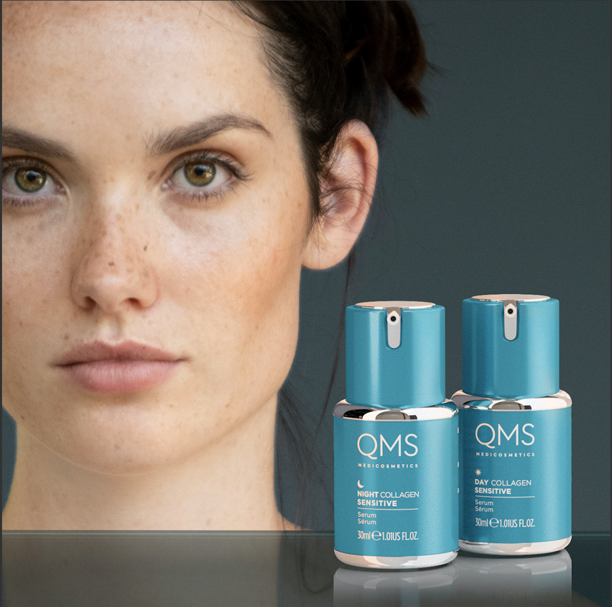 Blue and white bottles of QMS cosmetics displayed on a glass counter